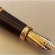 Picture Of Quill Pen Over A Paper Sheet